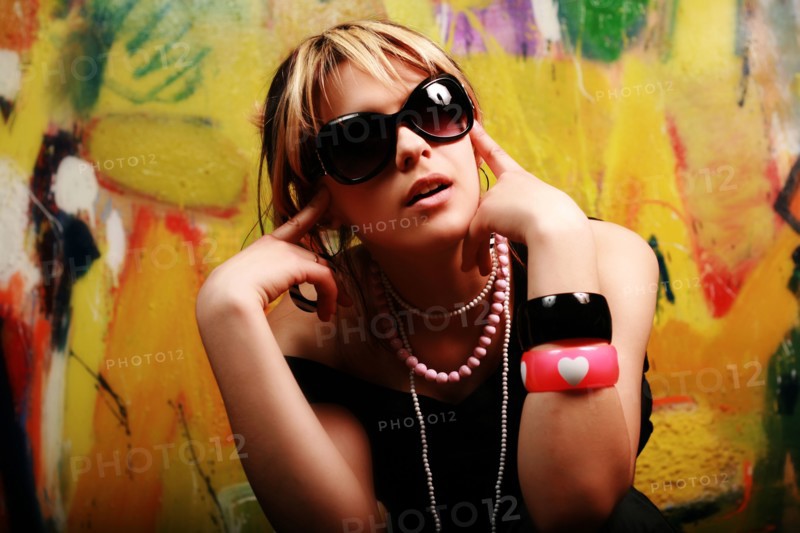 Portrait of glamorous Caucasian teenage girl wearing sunglasses