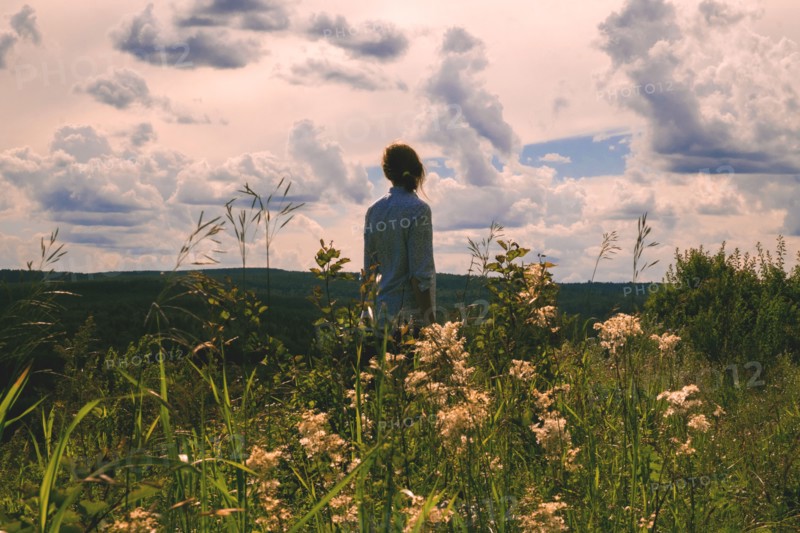 Woman standing in field of wildflowers
