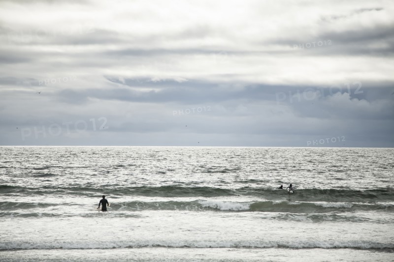 Surfers in ocean waves