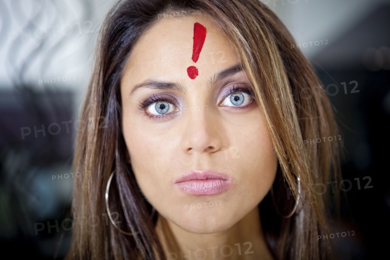 Hispanic woman with exclamation mark on her forehead