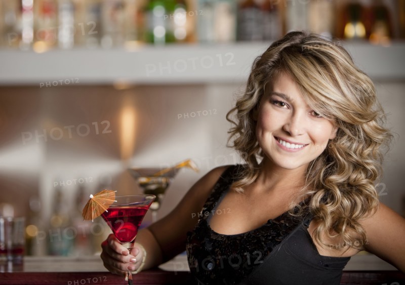 Hispanic woman drinking martini
