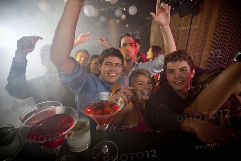 Hispanic friends dancing in nightclub
