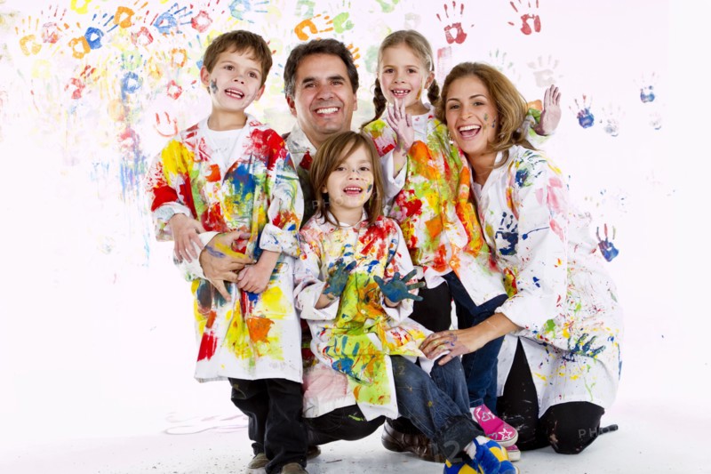 Hispanic family covered in paint