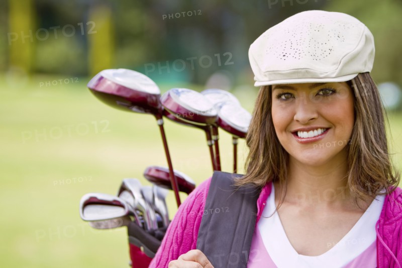 Hispanic woman playing golf