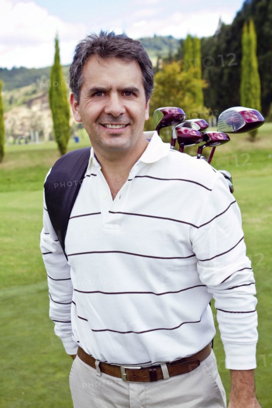 Hispanic man playing golf