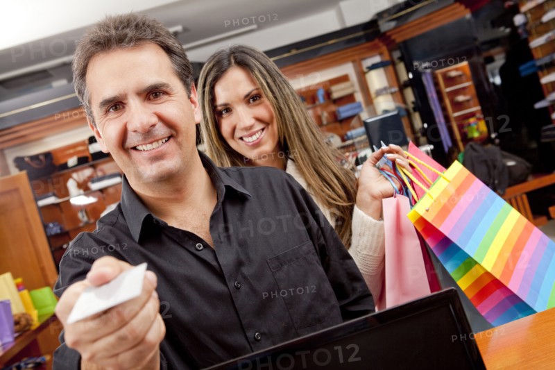 Hispanic man paying for shopping with credit card