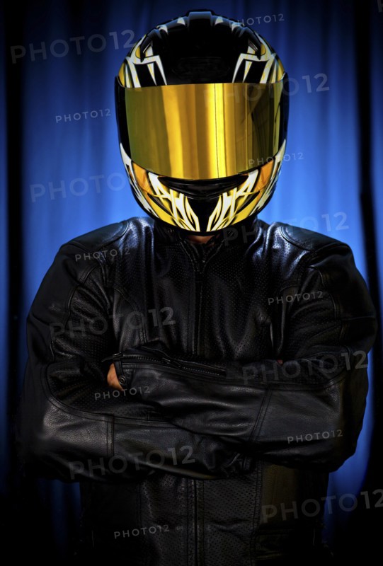 Hispanic biker in leather and reflective helmet