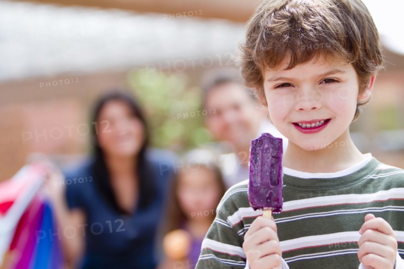 Hispanic boy eating popsicle