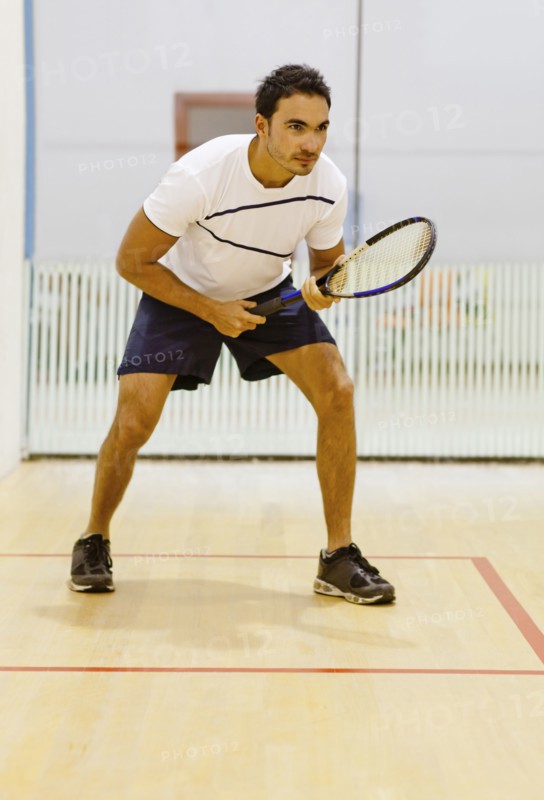 Hispanic man playing squash
