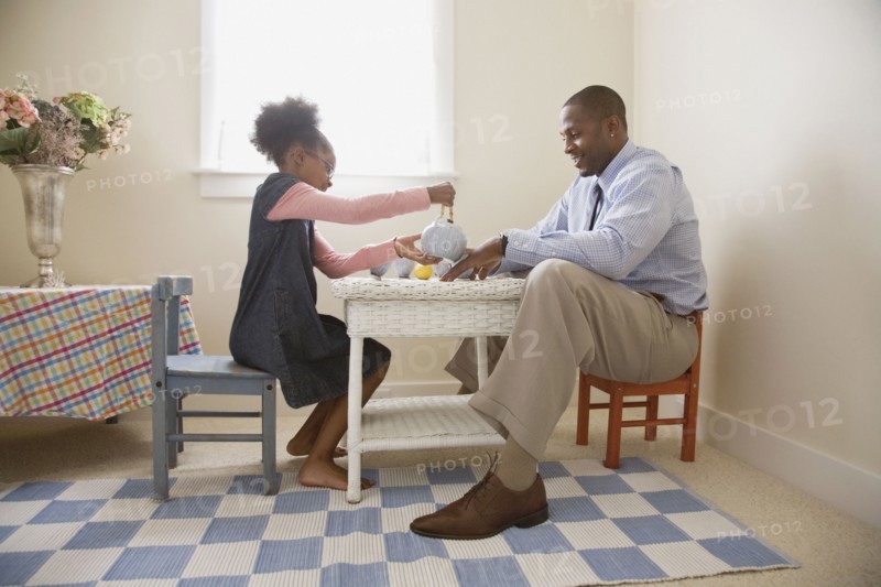 African father and daughter playing tea