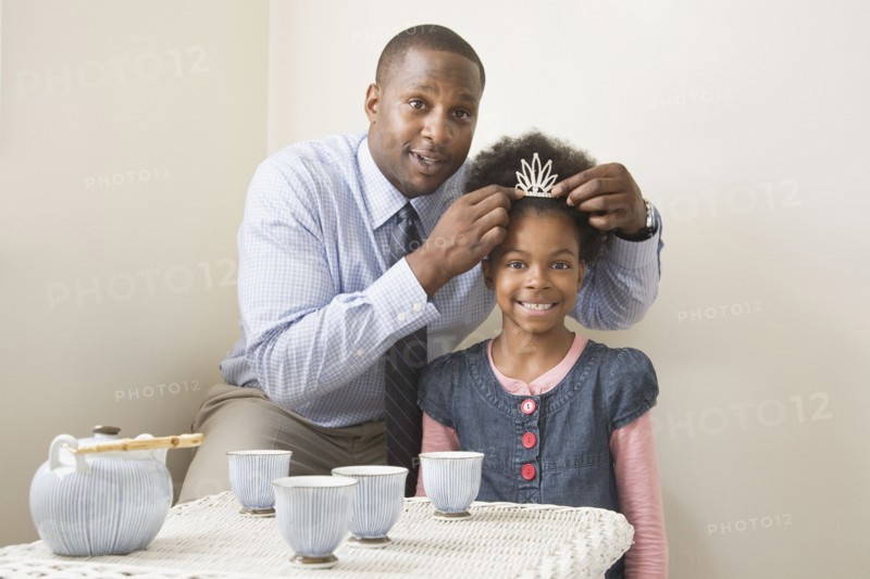 African father and daughter posing with tiara