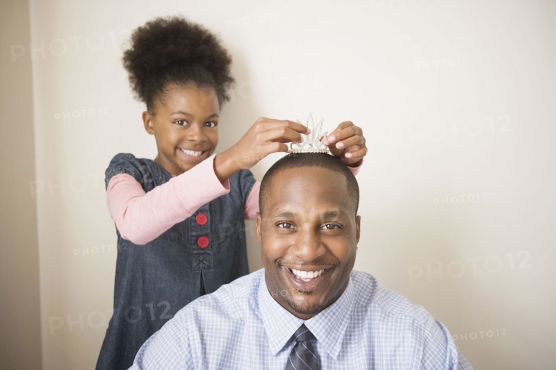 African father wearing daughter's tiara