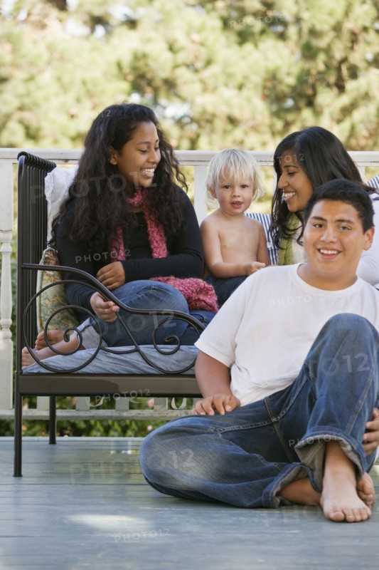 Hispanic family sitting on porch