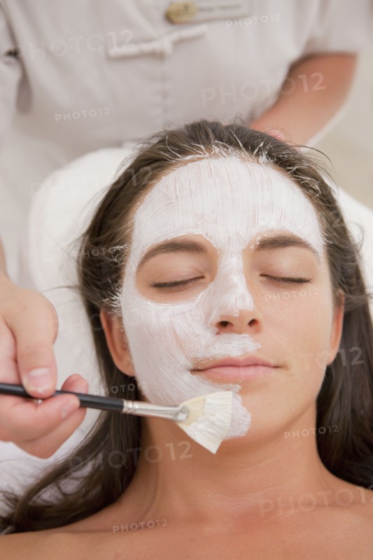 Woman having facial spa treatment