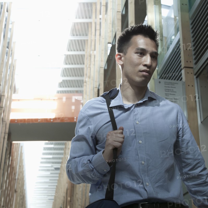 Chinese businessman walking on urban street