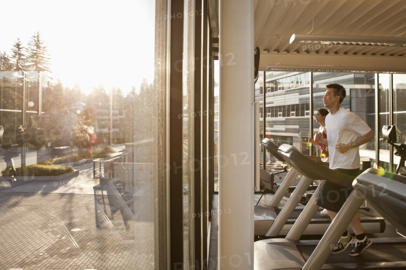 Man running on treadmill in health club