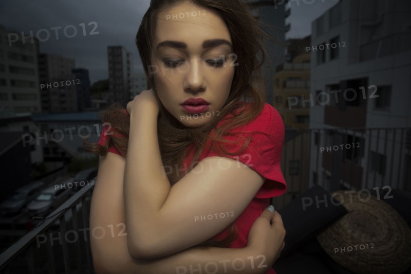 Caucasian woman standing on balcony