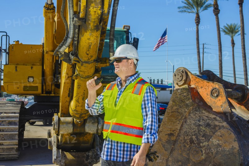 Caucasian construction worker using walkie-talkie