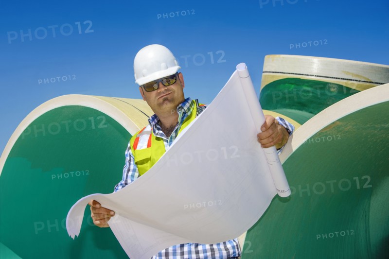 Caucasian construction worker reading blueprint