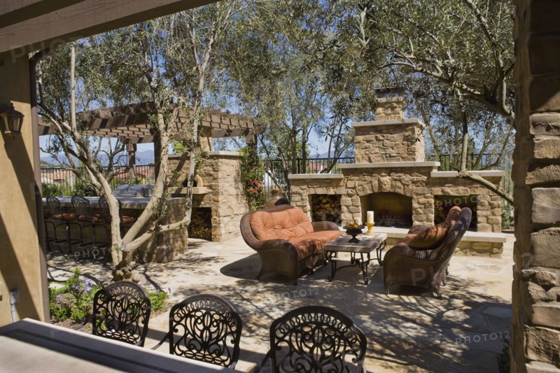 View over backyard bar to sitting area near fireplace