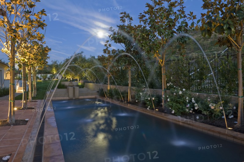 Crossing fountains across swimming pool