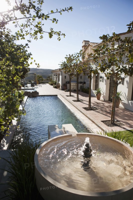 Backyard with fountain leading into swimming pool