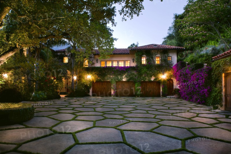 Stone shape tiled driveway in front of a Spanish style home