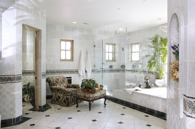 Interior of domestic bathroom with armchair and stool