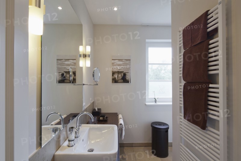 Towel warmer and sink in domestic bathroom