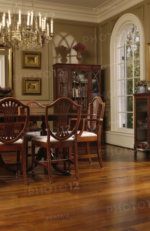 Elegant dining room with oak hardwood floors and hepplewhite style dining chairs