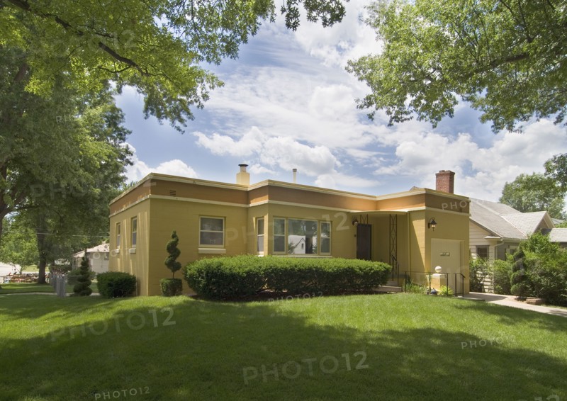 Exterior view of a yellow house with front yard at Lincoln