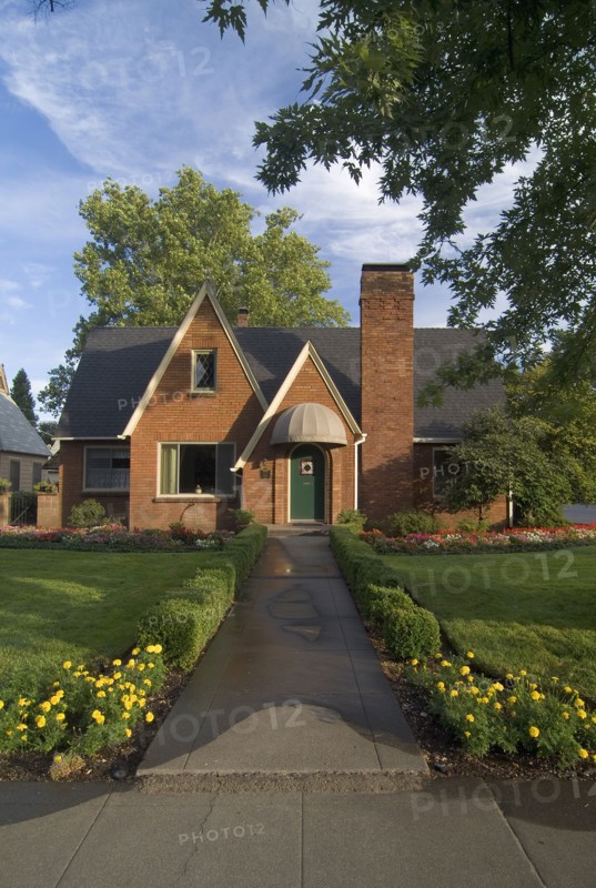 Exterior front view of red brick cottage with landscaping at Chico