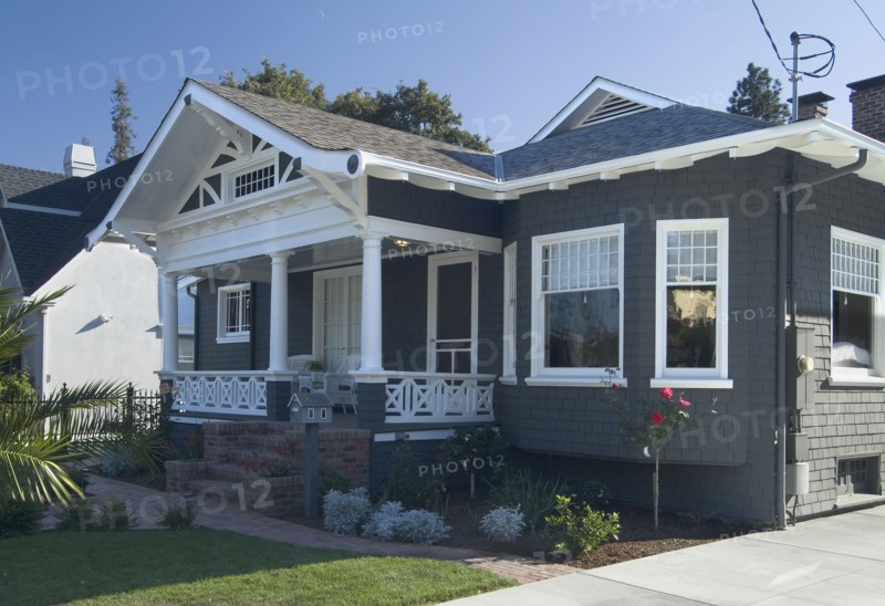 Front exterior view of a blue bungalow with white trim