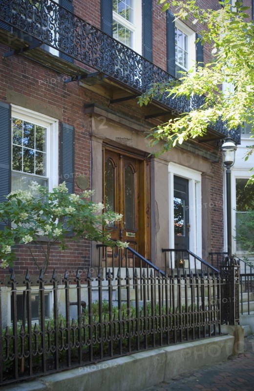 Brick apartment building with wrought iron fence
