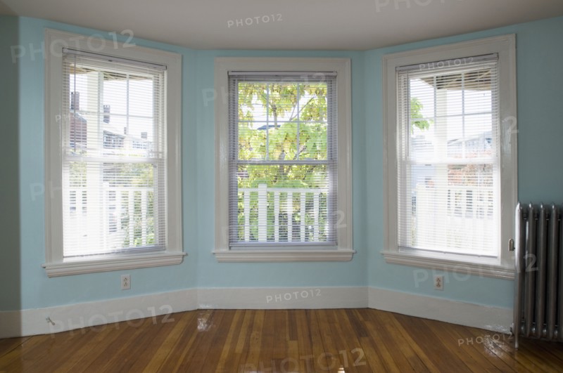 Empty room in apartment with hardwood floor and heater