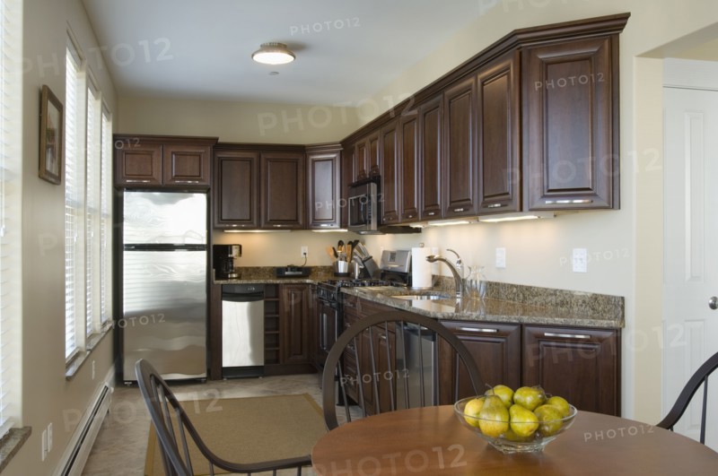 Contemporary kitchen with dark colored cabinets