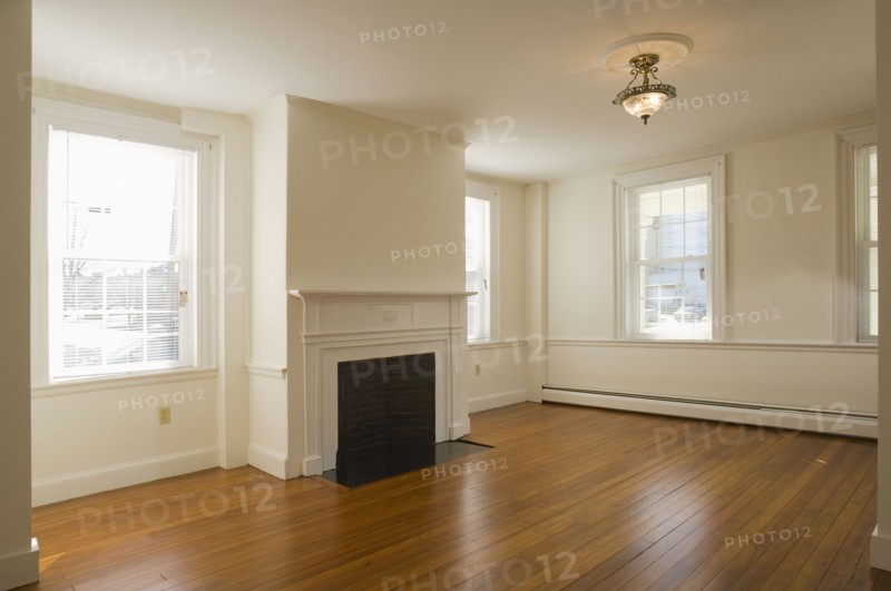 Empty room in apartment with hardwood floor and fireplace