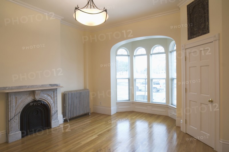 Empty room in apartment with hardwood floor and bay window