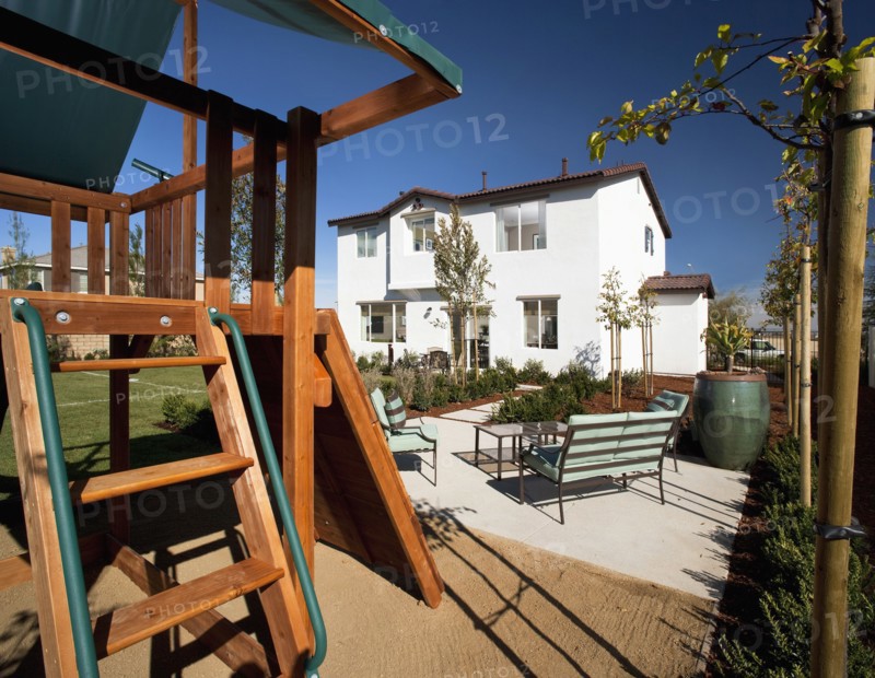 Swingset behind multiple story home