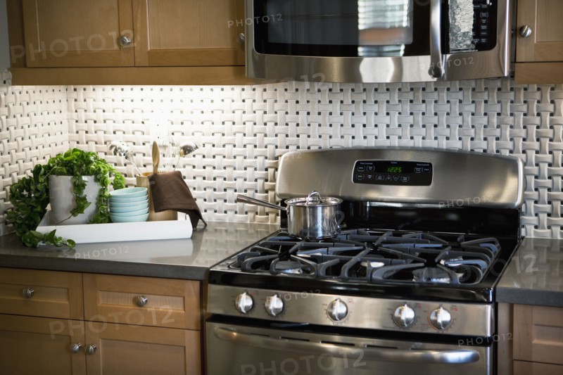 Stainless steel appliances in traditional kitchen
