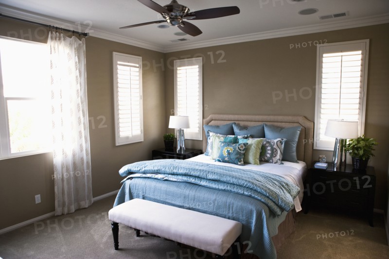 Collection of throw pillows on bed in bedroom