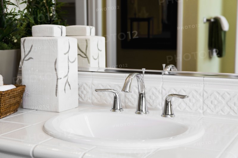 White tile countertop surrounding bathroom sink