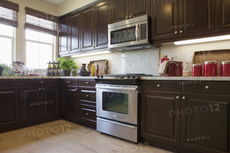 View of a kitchen having brown cabinets at home