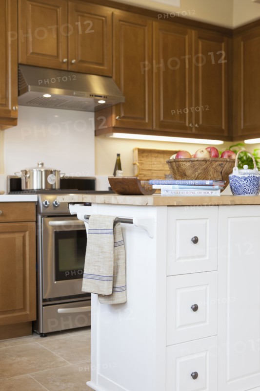 Kitchen with brown cabinets and island at home