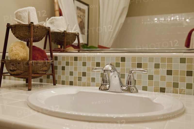 Close-up of tiled counter and washbasin in the bathroom at home
