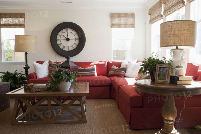 Contemporary living room with red sectional sofa and large wall clock at home