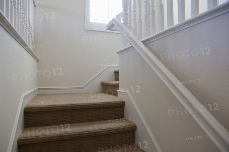 Close-up of stairs with white walls at home