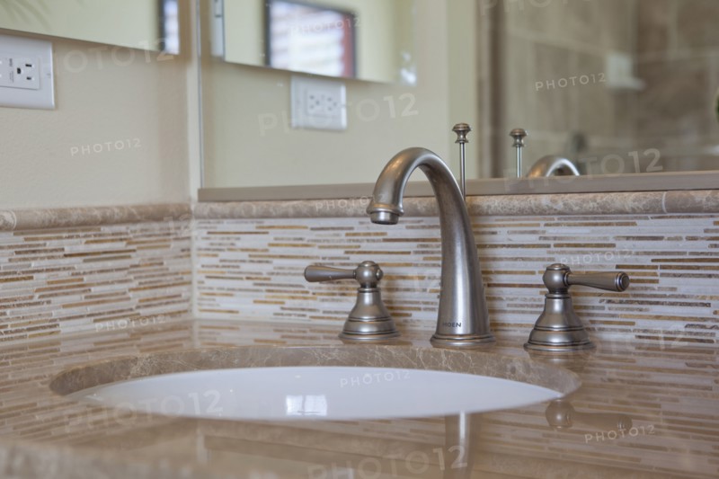 Contemporary bathroom with washbasin and mirror at home