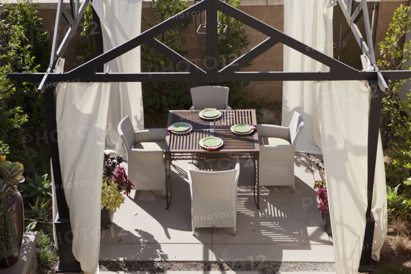 High angle view of dining area with curtains in the garden