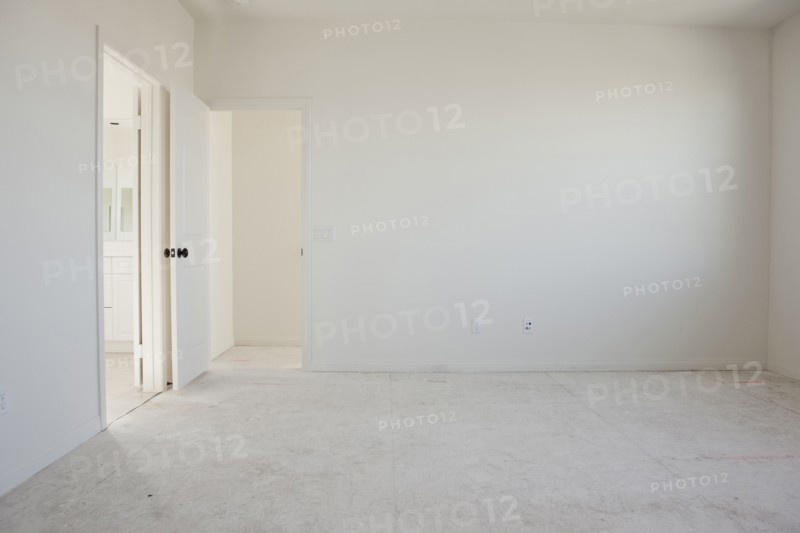Empty room with doorways and white floor